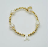 gold beads and baroque pearls with a mother of pearl initial bracelet